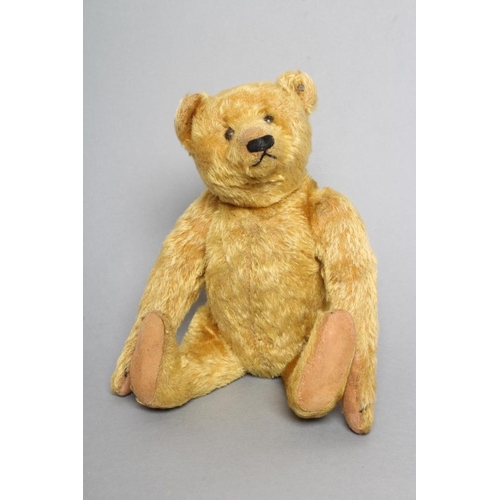 222 - An early Steiff teddy bear, with orange plush, button eyes, sewn nose, felt pads, long arms, back hu... 