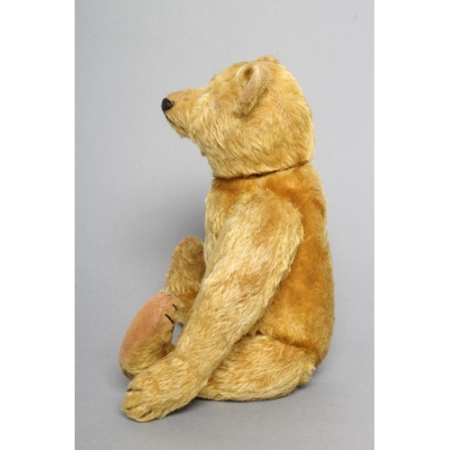 222 - An early Steiff teddy bear, with orange plush, button eyes, sewn nose, felt pads, long arms, back hu... 