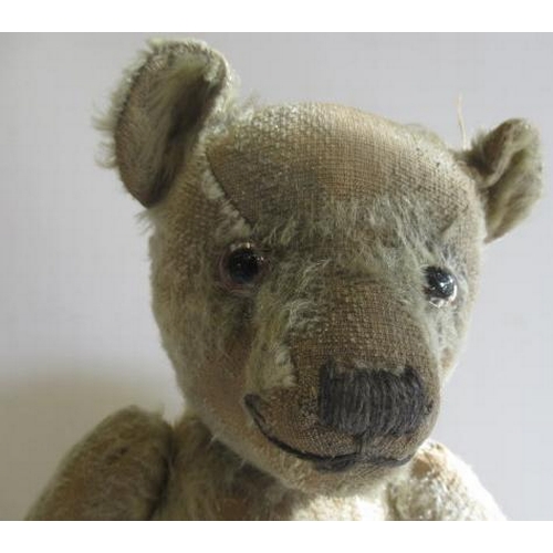 224 - A pre-war jointed teddy bear, straw filled with glass eyes, sewn nose and cloth pads, 16