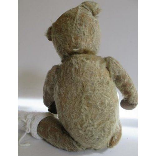 224 - A pre-war jointed teddy bear, straw filled with glass eyes, sewn nose and cloth pads, 16