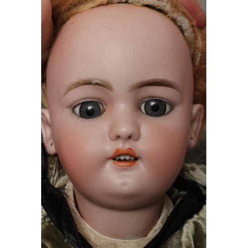 23 - A Simon & Halbig bisque socket head doll, with blue glass sleeping eyes, open mouth, teeth, pierced ... 