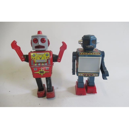 329 - Yonega Toys clockwork robot, tinplate body with plastic head, working motor and action, and a tin an... 