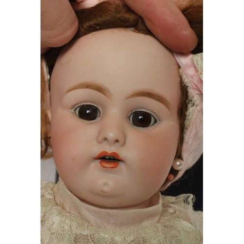 40 - A Simon & Halbig bisque socket head doll, with brown glass fixed eyes, open mouth, teeth, pierced ea... 