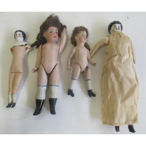 52 - Four antique dolls, comprising two china shoulder head dolls, with cloth bodies and bisque lower arm... 