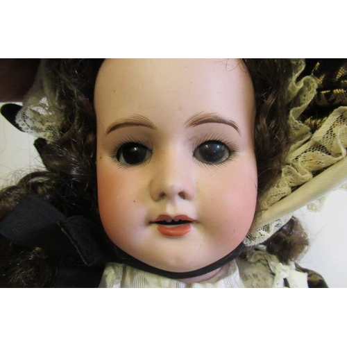 67 - An SFBJ bisque socket head doll, with brown glass sleeping eyes, open mouth, teeth, dark brown wig, ... 