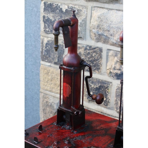 789 - A floor standing garage oil dispenser pump finished in red with two pumps, Double Shell and Triple S... 