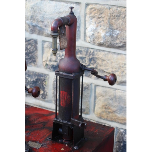 789 - A floor standing garage oil dispenser pump finished in red with two pumps, Double Shell and Triple S... 