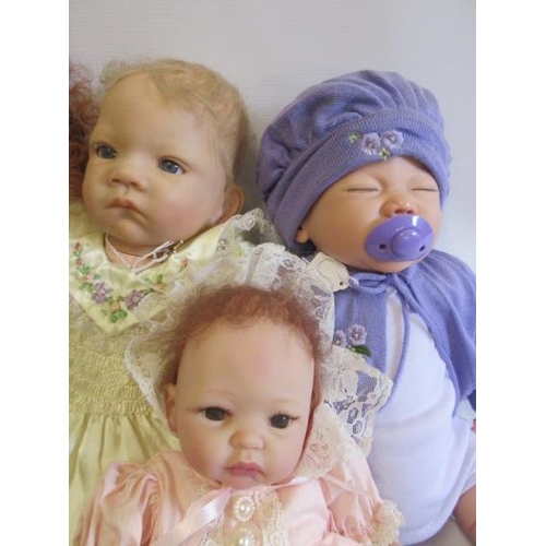 79 - Four dolls comprising a Lee Middleton Reva doll and three Ashton Drake dolls, one drake example with... 