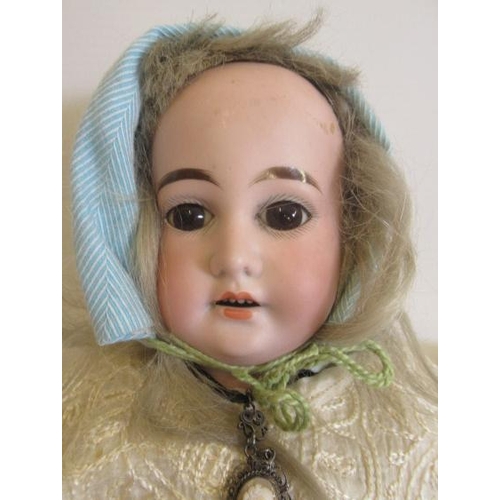 89 - A Cuno & Otto Dressel bisque shoulder head doll, with brown glass fixed eyes, open mouth, teeth, blo... 