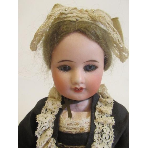 95 - An SFBJ bisque socket head doll, with blue glass fixed eyes, open mouth, teeth, light brown wig, com... 