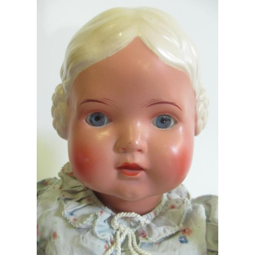 98 - A Rheinische Gummi celluloid girl, with blue glass fixed eyes, moulded hair and features, jointed bo... 