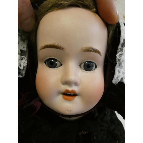 13 - A Schoenau & Hoffmeister bisque socket head doll, with blue glass sleeping eyes, open mouth, teeth, ... 