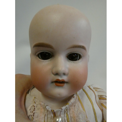 43 - An Armand Marseille bisque shoulder head doll, with brown glass sleeping eyes, open mouth, teeth, cu... 