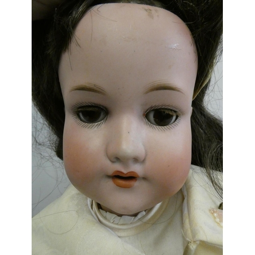 5 - An Armand Marseille bisque socket head doll, with brown glass sleeping eyes, open mouth, teeth, brow... 