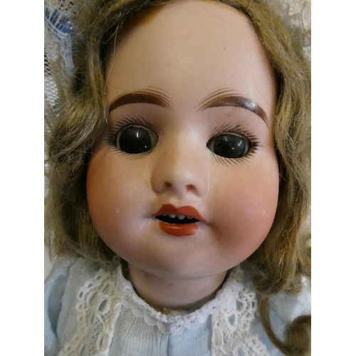 55 - An SFBJ bisque socket head doll, with brown glass sleeping eyes, open mouth, teeth, light brown wig,... 