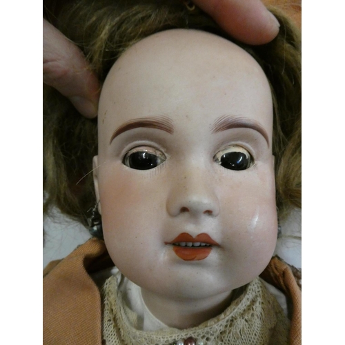 61 - An SFBJ bisque socket head doll, with brown glass sleeping eyes, open mouth, 6 top teeth, pierced ea... 