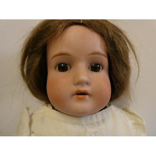 7 - An Armand Marseille bisque shoulder head doll, with fixed brown eyes, open mouth, teeth, jointed kid... 