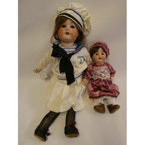 9 - Two bisque socket head dolls, comprising a Hermann Steiner sailor doll, with brown glass sleeping ey... 