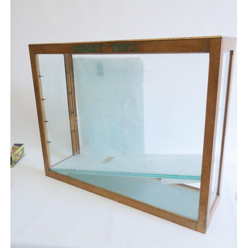 612 - A glass toy shop display cabinet, wooden frame, with four glass shelves, DINKY TOYS to front, 30