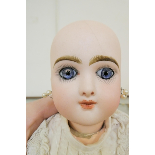 153 - A Bebe Jumeau bisque socket head doll, with blue glass paperweight fixed eyes, closed mouth, pierced... 