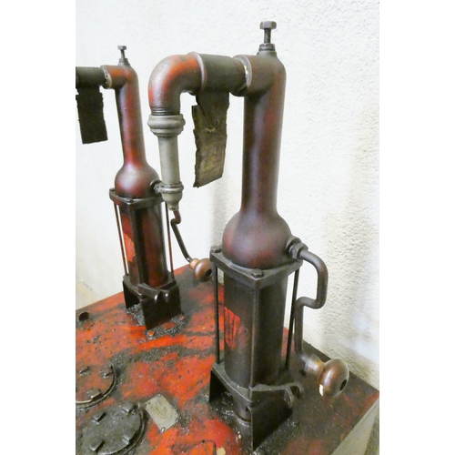 789 - A floor standing garage oil dispenser pump finished in red with two pumps, Double Shell and Triple S... 