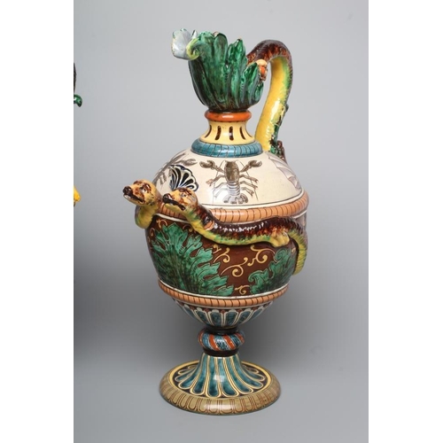 15 - A PAIR OF MAIOLICA PEDESTAL EWERS, c.1900, of ovoid form with acanthus lip, bi-furcated snake's head... 