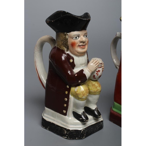 24 - A PEARLWARE SMALL TOBY JUG, c.1800, wearing a tricorn hat, red coat, pink waistcoat and yellow breec... 