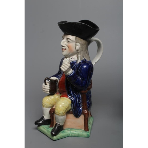 25 - A STAFFORDSHIRE POTTERY SQUIRE TOBY JUG, early 20th century, wearing a black tricorn hat, underglaze... 