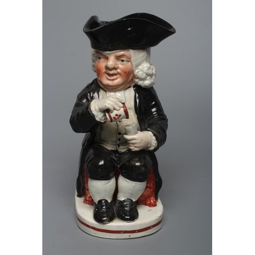 26 - AN ENOCH WOOD TYPE EARTHENWARE DRUNKEN PARSON OR DR. JOHNSON TOBY JUG, c.1800, wearing a black trico... 