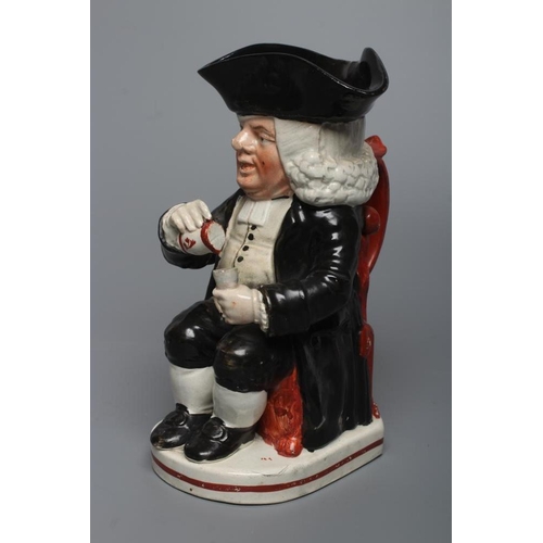 26 - AN ENOCH WOOD TYPE EARTHENWARE DRUNKEN PARSON OR DR. JOHNSON TOBY JUG, c.1800, wearing a black trico... 