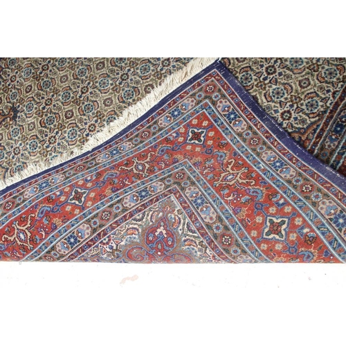 294 - A PERSIAN RUG, the ivory field with all over repeating flowerhead and leaf pattern in shades of blue... 