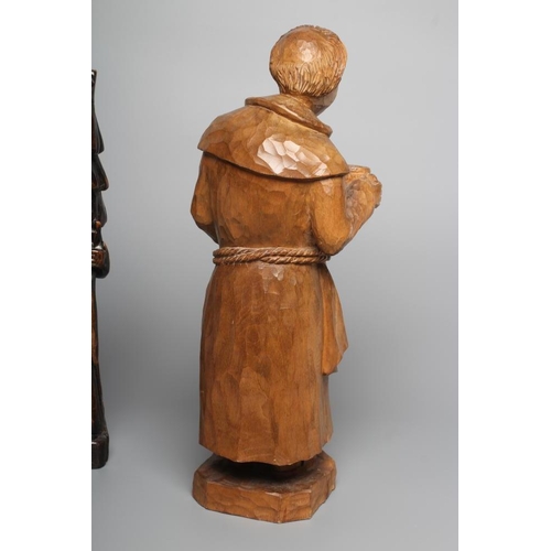 295 - A CARVED LIMEWOOD(?) FIGURE OF A MONK, 20th century, modelled standing wearing an apron and holding ... 