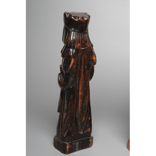 295 - A CARVED LIMEWOOD(?) FIGURE OF A MONK, 20th century, modelled standing wearing an apron and holding ... 