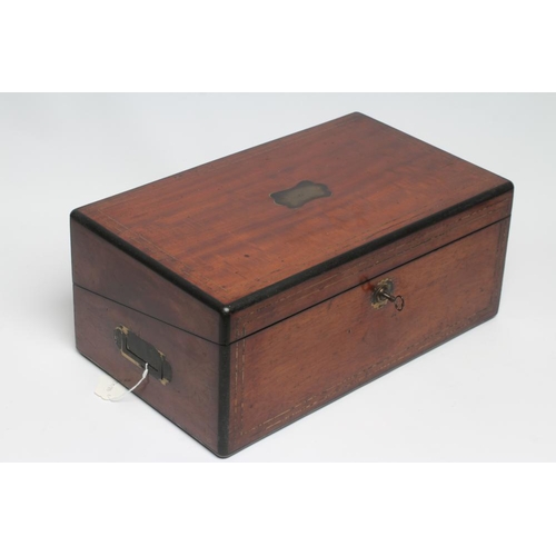 296 - A VICTORIAN MAHOGANY AND BRASS BOUND LAP DESK, the lid inset with brass shield inscribed 