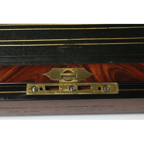 296 - A VICTORIAN MAHOGANY AND BRASS BOUND LAP DESK, the lid inset with brass shield inscribed 