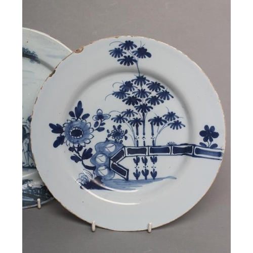 30 - AN ENGLISH DELFT PLATE, London c.1760, of plain circular form painted in blue with a lady perched on... 