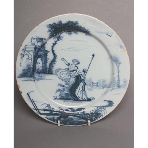 30 - AN ENGLISH DELFT PLATE, London c.1760, of plain circular form painted in blue with a lady perched on... 