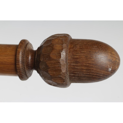 302 - AN ADZED OAK CURTAIN POLE BY ALAN GRAINGER OF BRANDSBY, in two sections with wooden hanging rings an... 