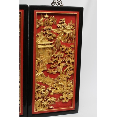 312 - A PAIR OF CHINESE CARVED WOOD WALL PANELS, 20th century, gilded with garden scenes in high relief on... 