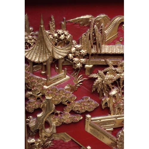 312 - A PAIR OF CHINESE CARVED WOOD WALL PANELS, 20th century, gilded with garden scenes in high relief on... 