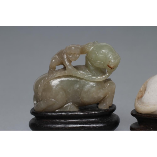 315 - TWO CHINESE JADEITE CARVINGS, one in greenish grey of a horse with a monkey on its back holding a ro... 