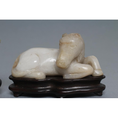 315 - TWO CHINESE JADEITE CARVINGS, one in greenish grey of a horse with a monkey on its back holding a ro... 