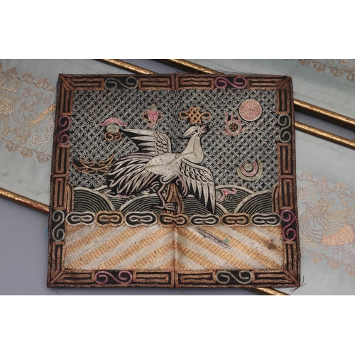 316 - A CHINESE BLACK SILK RANK BADGE, couched in metallic threads and coloured silks with an exotic bird ... 