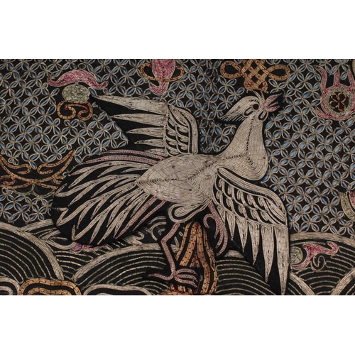 316 - A CHINESE BLACK SILK RANK BADGE, couched in metallic threads and coloured silks with an exotic bird ... 