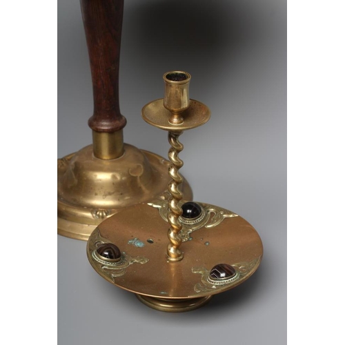 325 - A VICTORIAN BRASS INKWELL of dished circular form, the spherical well with two ring handles on a sli... 