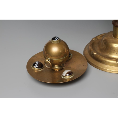 325 - A VICTORIAN BRASS INKWELL of dished circular form, the spherical well with two ring handles on a sli... 