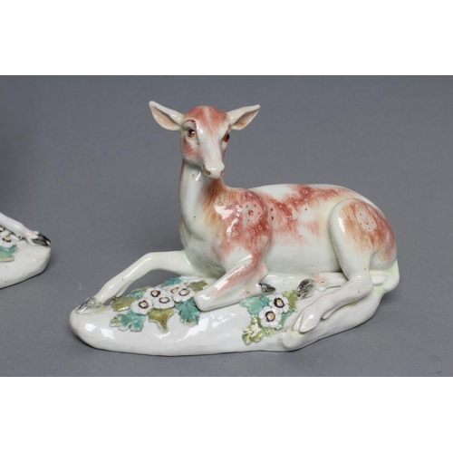 49 - A DERBY PORCELAIN STAG AND HIND, c.1760, each modelled recumbent on a flower encrusted shaped base, ... 