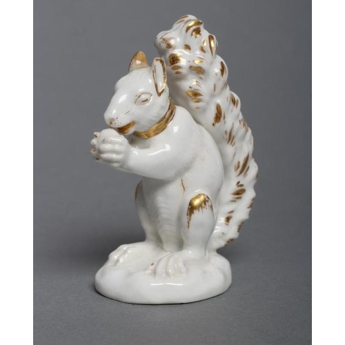 53 - A DERBY PORCELAIN SQUIRREL, c.1800, modelled holding a nut to its mouth, with gilded highlights, inc... 