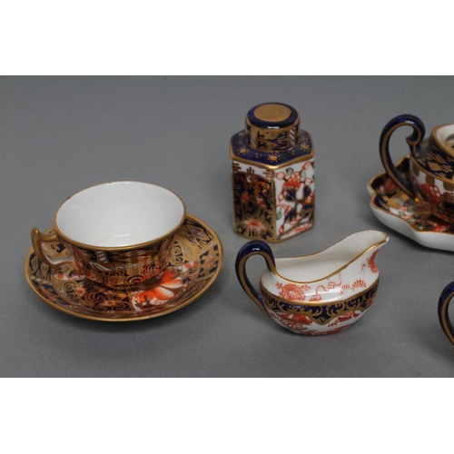 63 - A ROYAL CROWN DERBY CHINA THREE PIECE IMARI PATTERN MINIATURE TEA SERVICE, 1919, with prow teapot, t... 