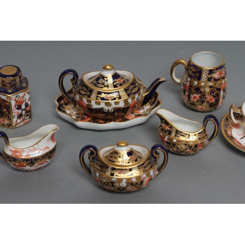 63 - A ROYAL CROWN DERBY CHINA THREE PIECE IMARI PATTERN MINIATURE TEA SERVICE, 1919, with prow teapot, t... 